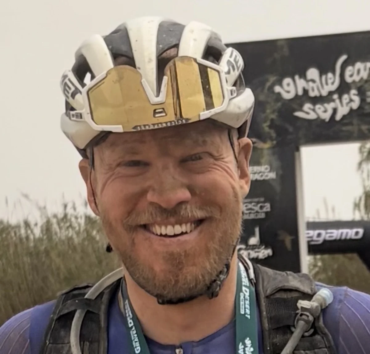 Kabir at a gravel race finish line, smiling.